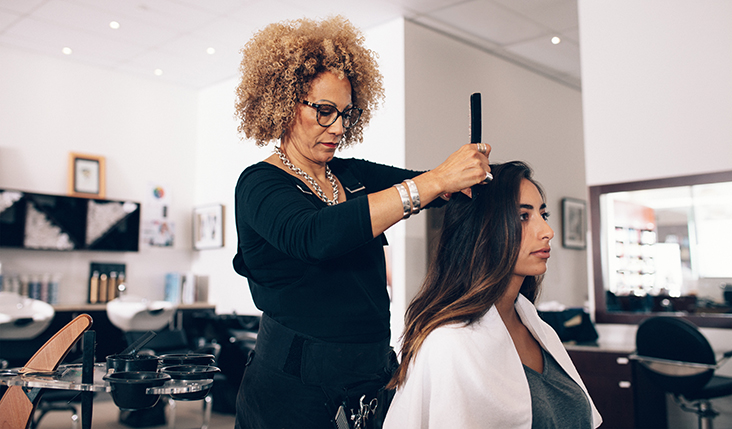 Woman styling client hair