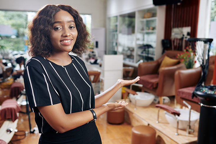 Salon owner with arms extended