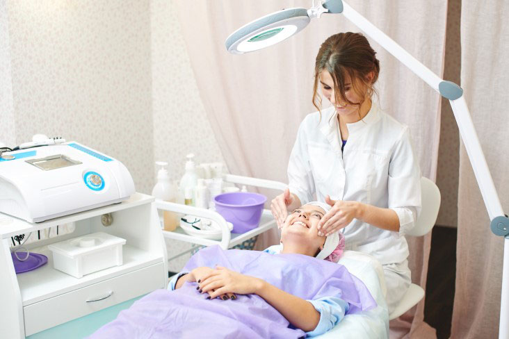 skincare expert evaluating a patient