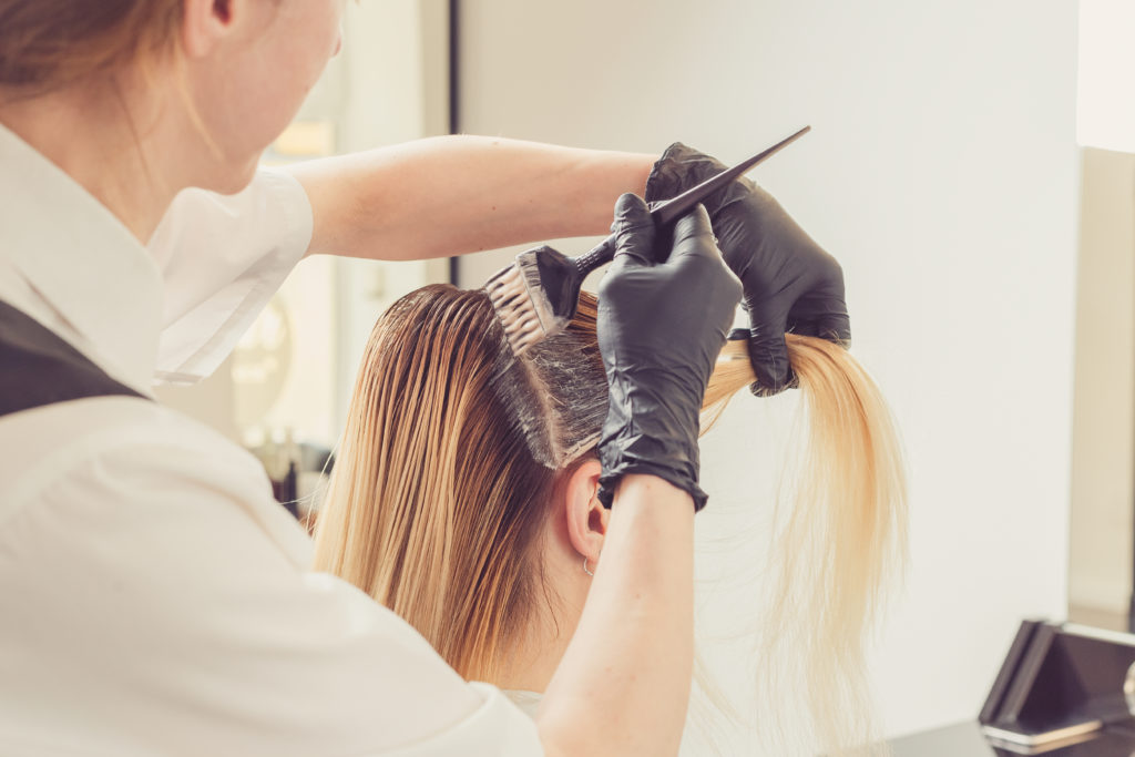 Cosmetology professional doing hair coloring