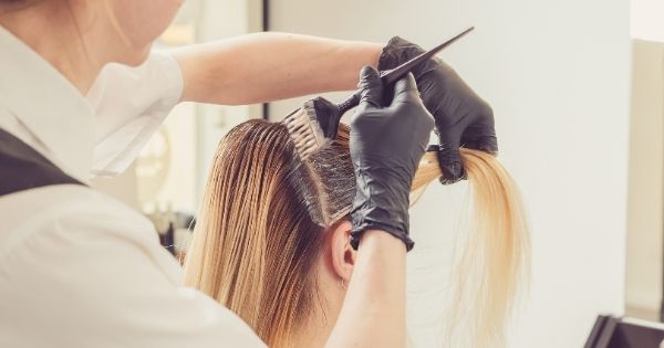 Cosmetology professional doing hair coloring