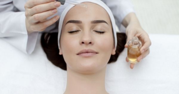 Esthetician applying skincare products.