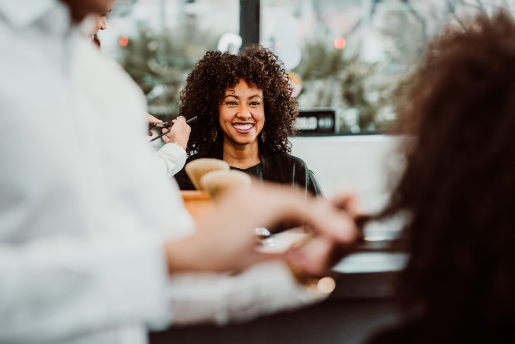 a woman with textured hair is at a beauty salon