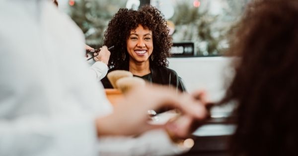 a woman with textured hair is at a beauty salon