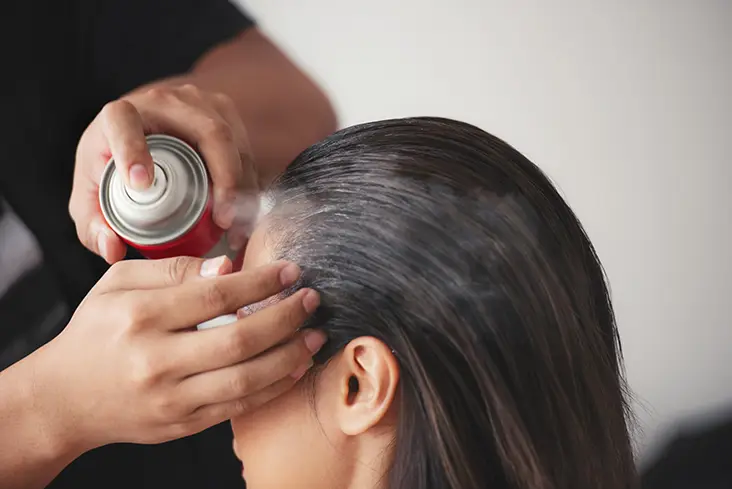 spraying hair for hold