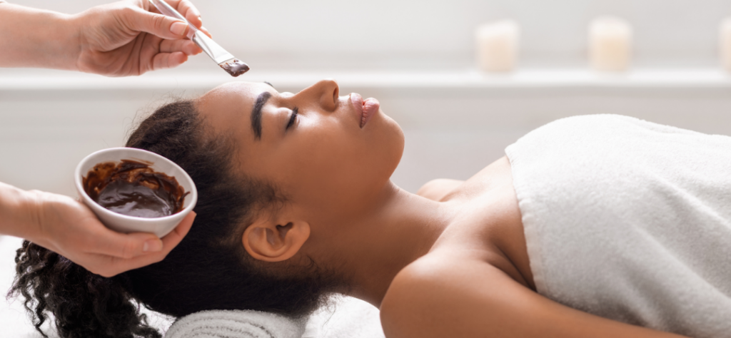 picture of Esthetician student performing facial treatment on a client