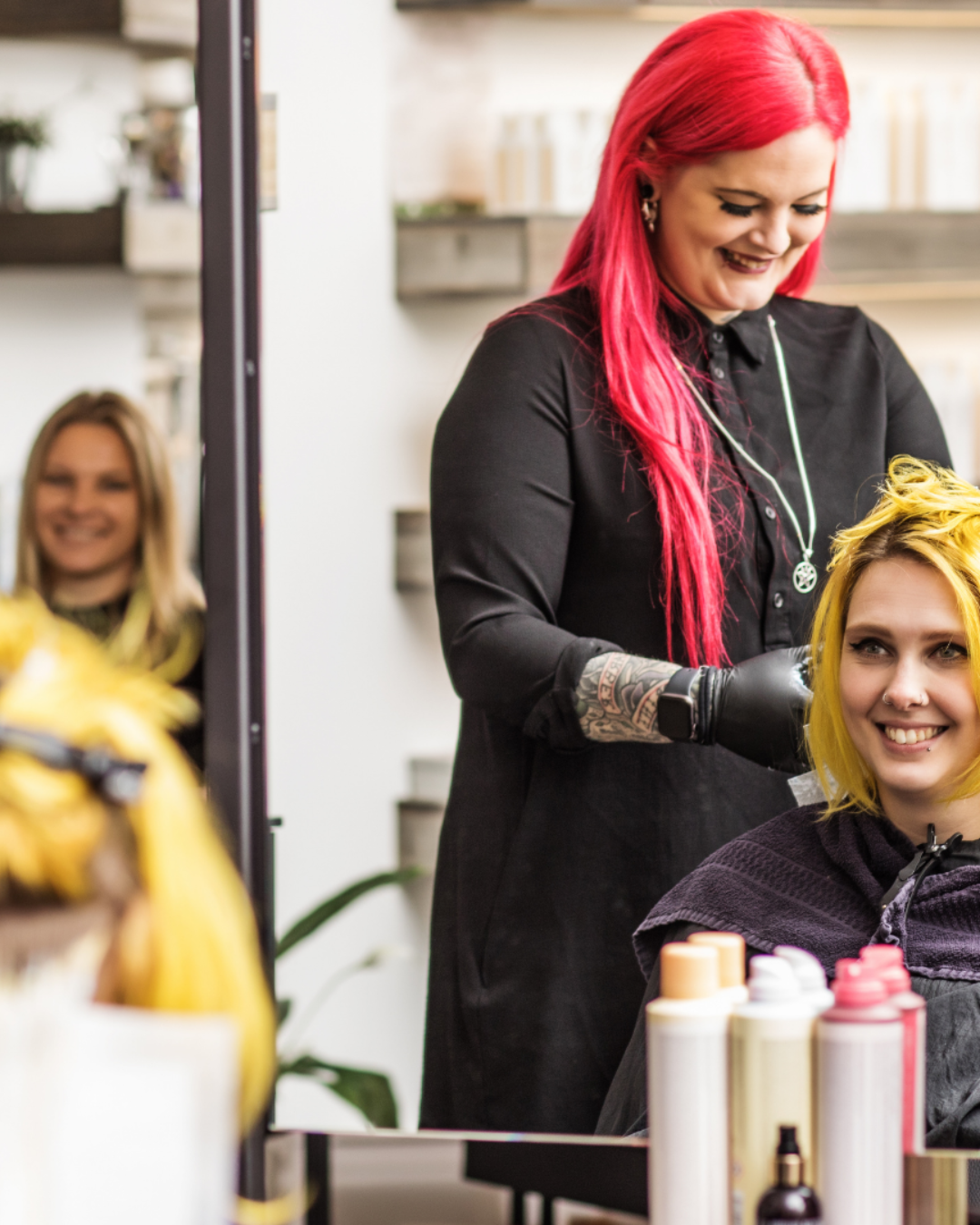 Picture of beauty school student applying color techniques to smiling client