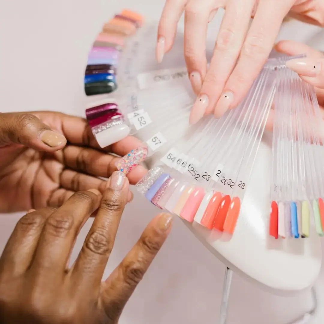 Image of a beauty school student performing nail services on a client
