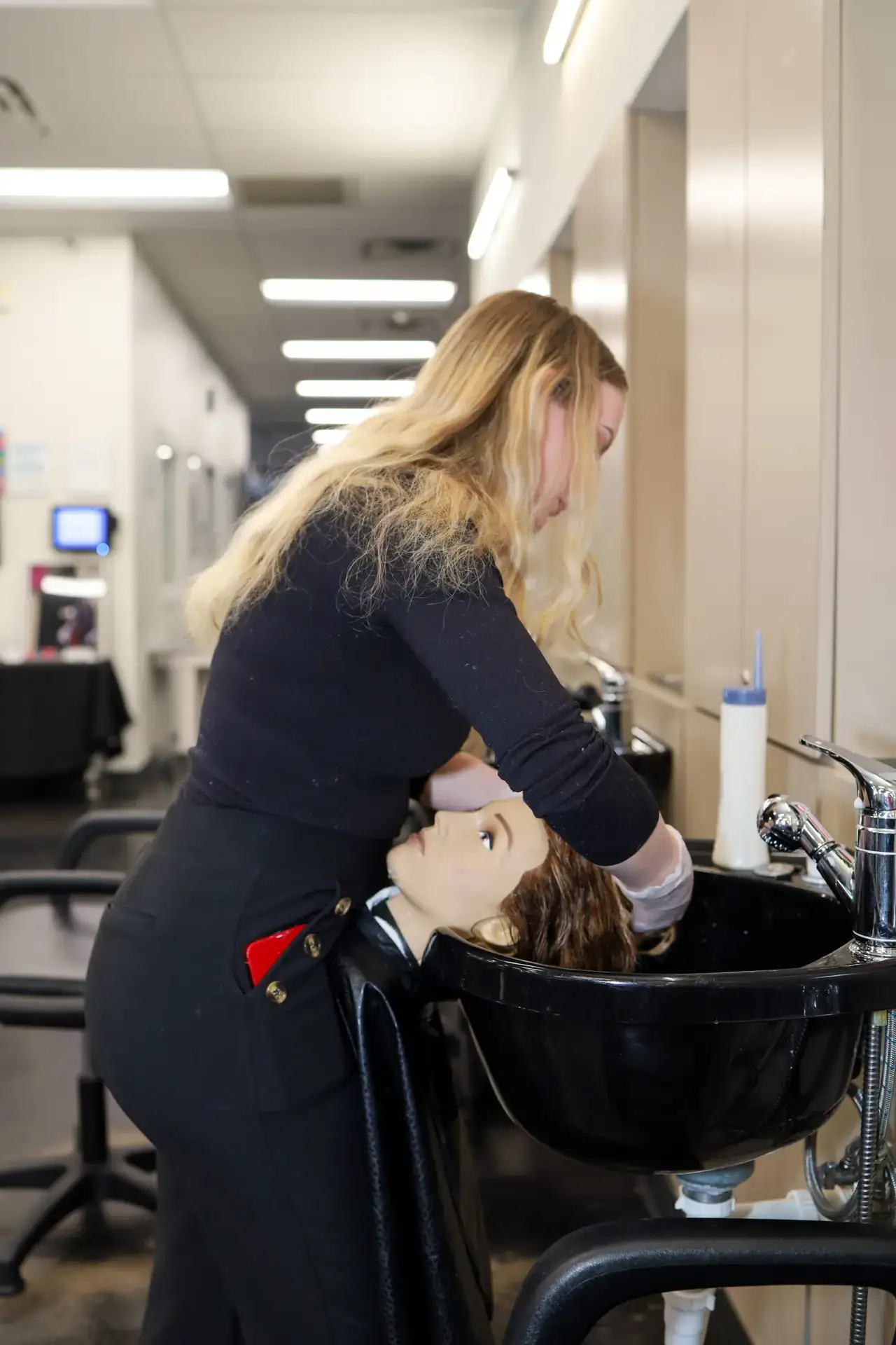 Ogle school cosmetology student performing hair services