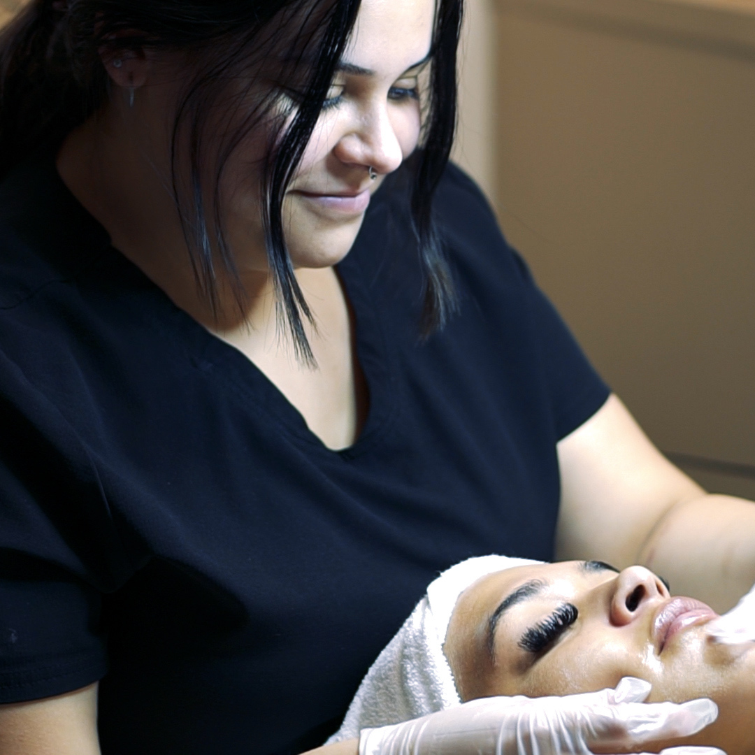 Ogle school esthetics student performing a facial