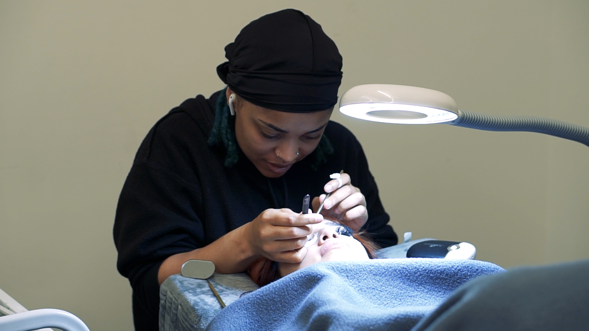 Ogle school Houston esthetics school student performing facial