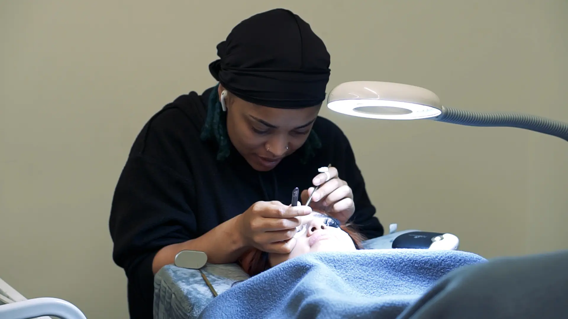 Ogle school Houston esthetics school student performing facial