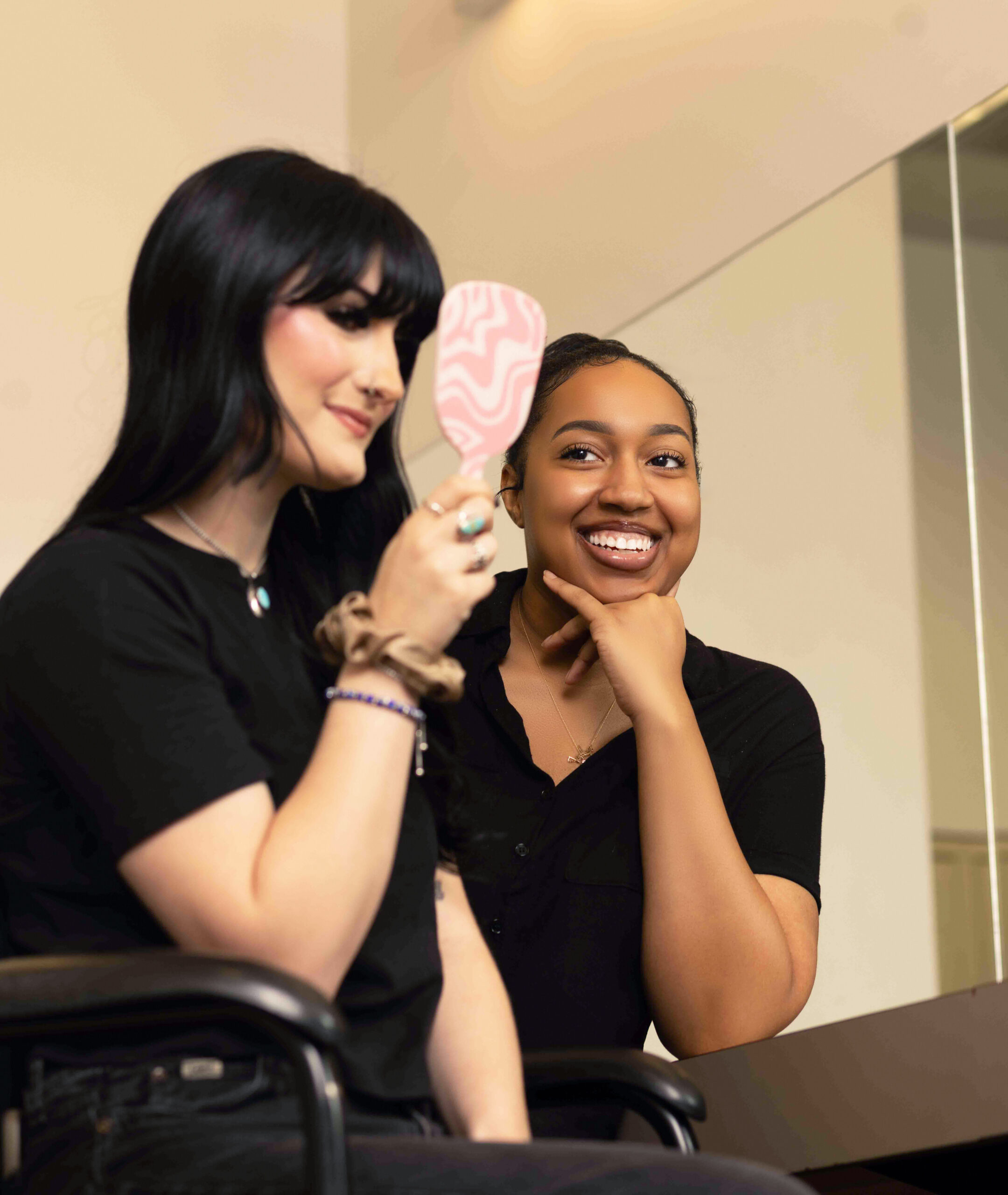 Ogle school esthetics student admiring her make up work