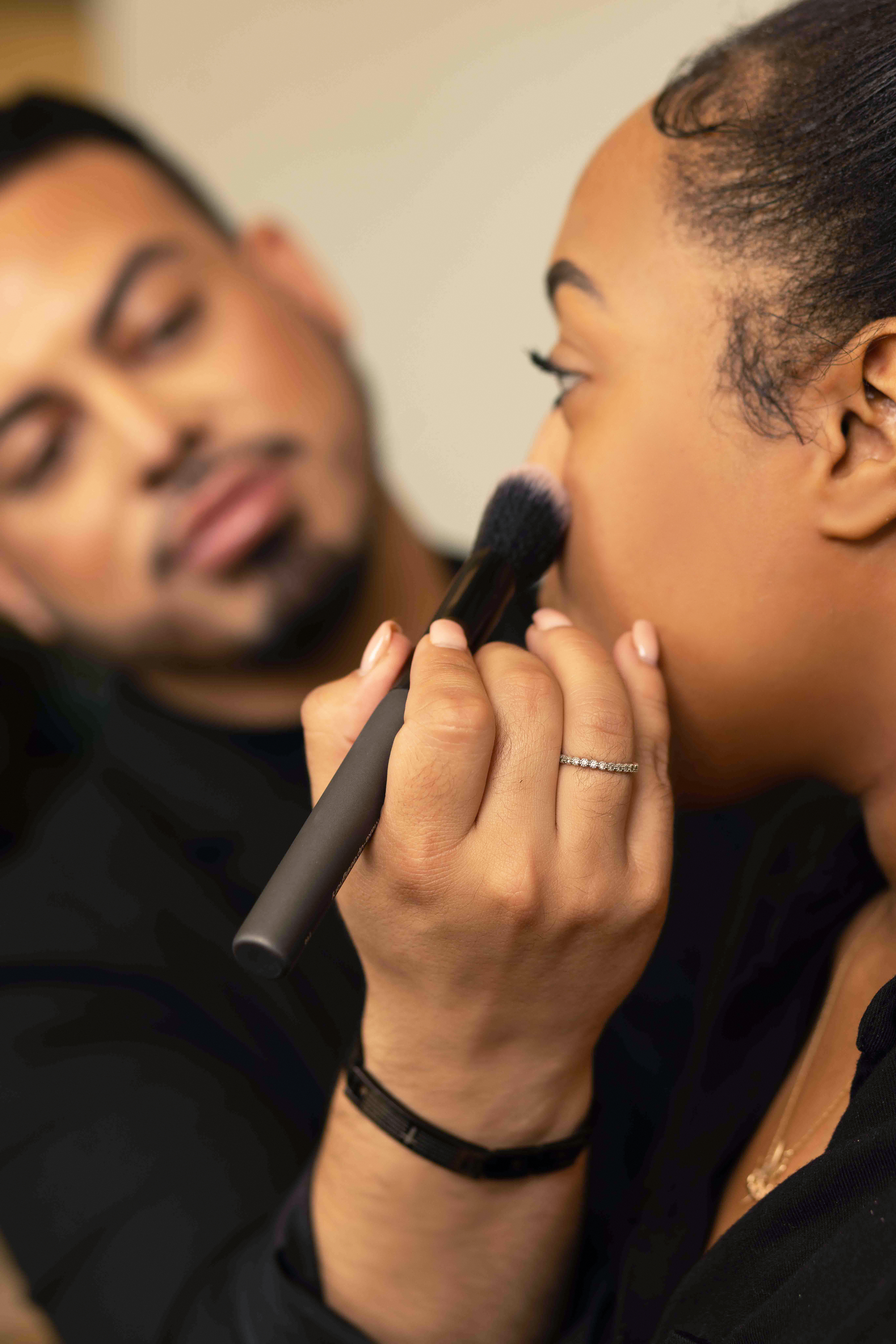 Ogle school esthetics student performing make up services
