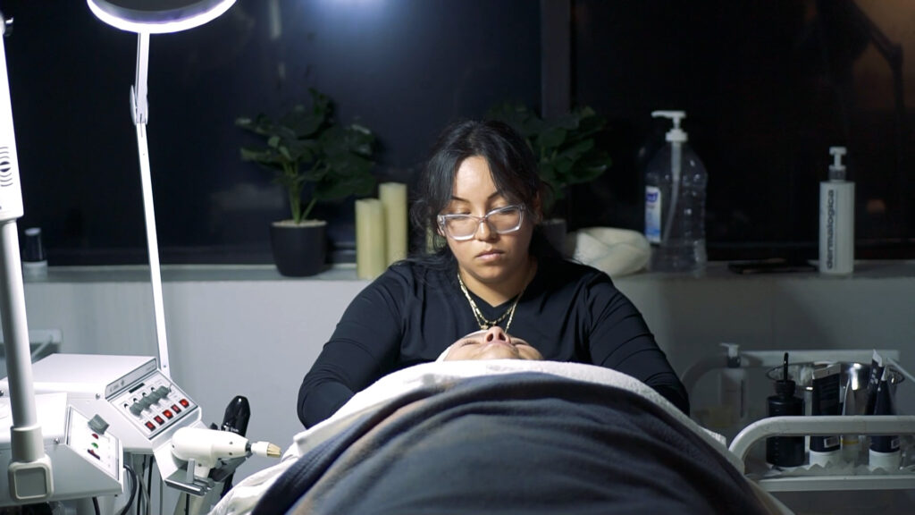 Ogle school esthetician student practicing her facial skills