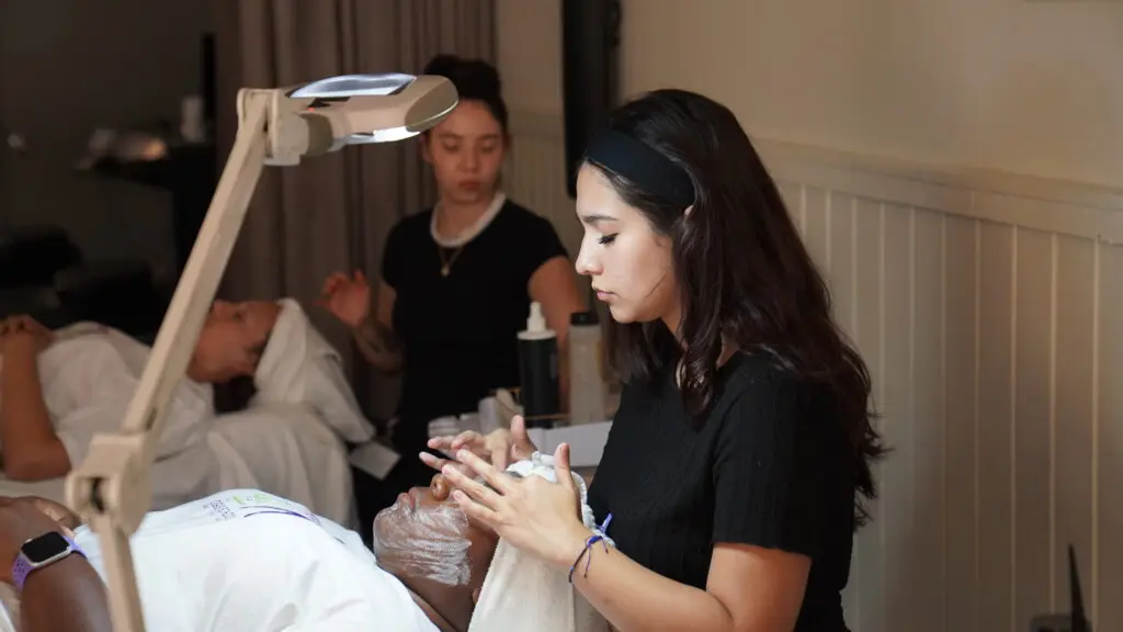 Image of Ogle school student performing facial on a client