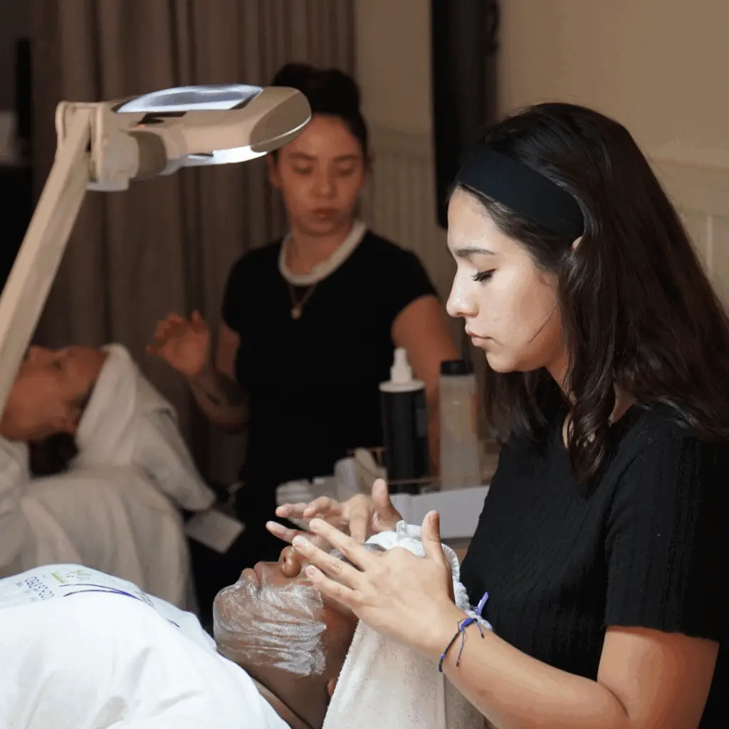 Image of Ogle school student performing facial on a client