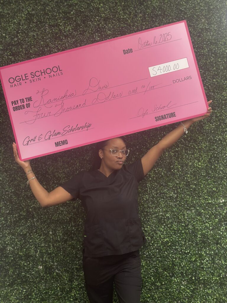 Image of ogle school student receiving a big check for the $4,000 Grit and Glam Scholarship