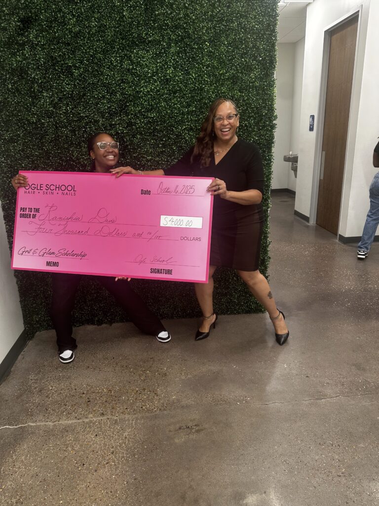 Image of ogle school student receiving a big check for the $4,000 Grit and Glam Scholarship