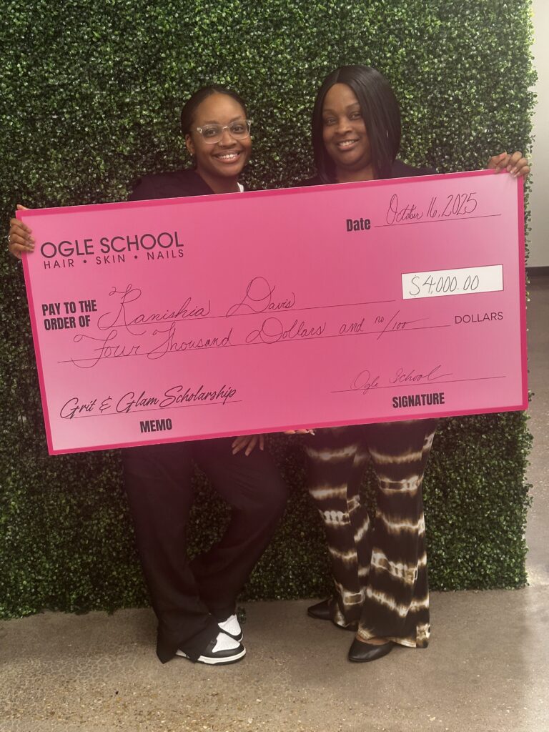 Image of ogle school student receiving a big check for the $4,000 Grit and Glam Scholarship