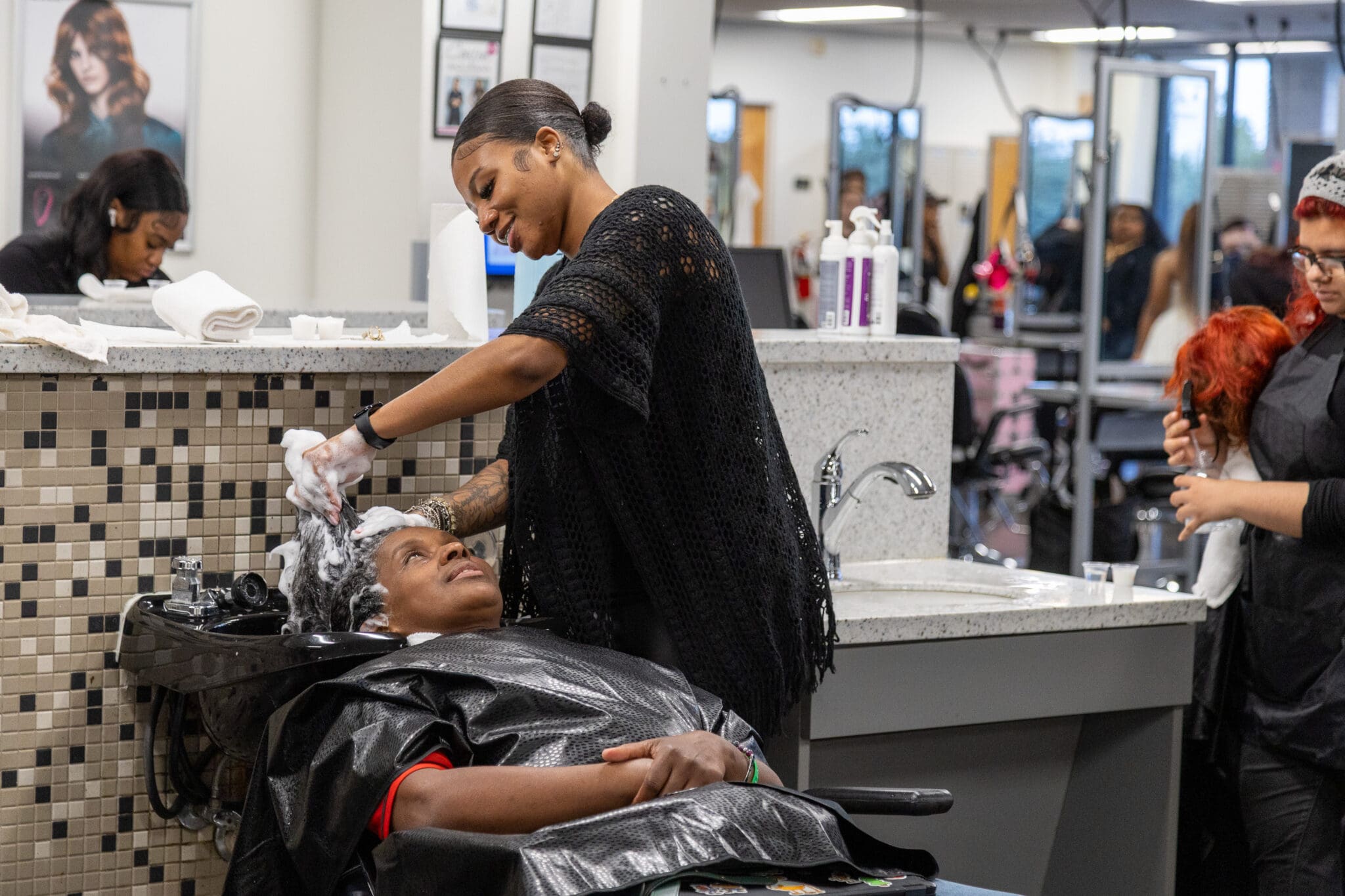 Image of Ogle School student performing a hair wash service