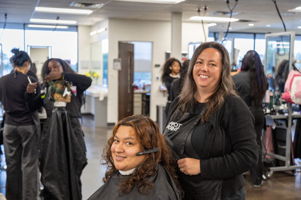 Ogle school student working with a client while still in beauty school