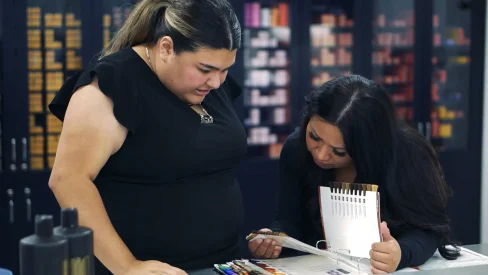 picture of two Cosmetology school students studying the business side of beauty